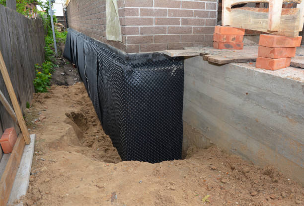 SJ Waterproofing Pros technician performing targeted Interior Drainage System assessment in Cottondale, AL